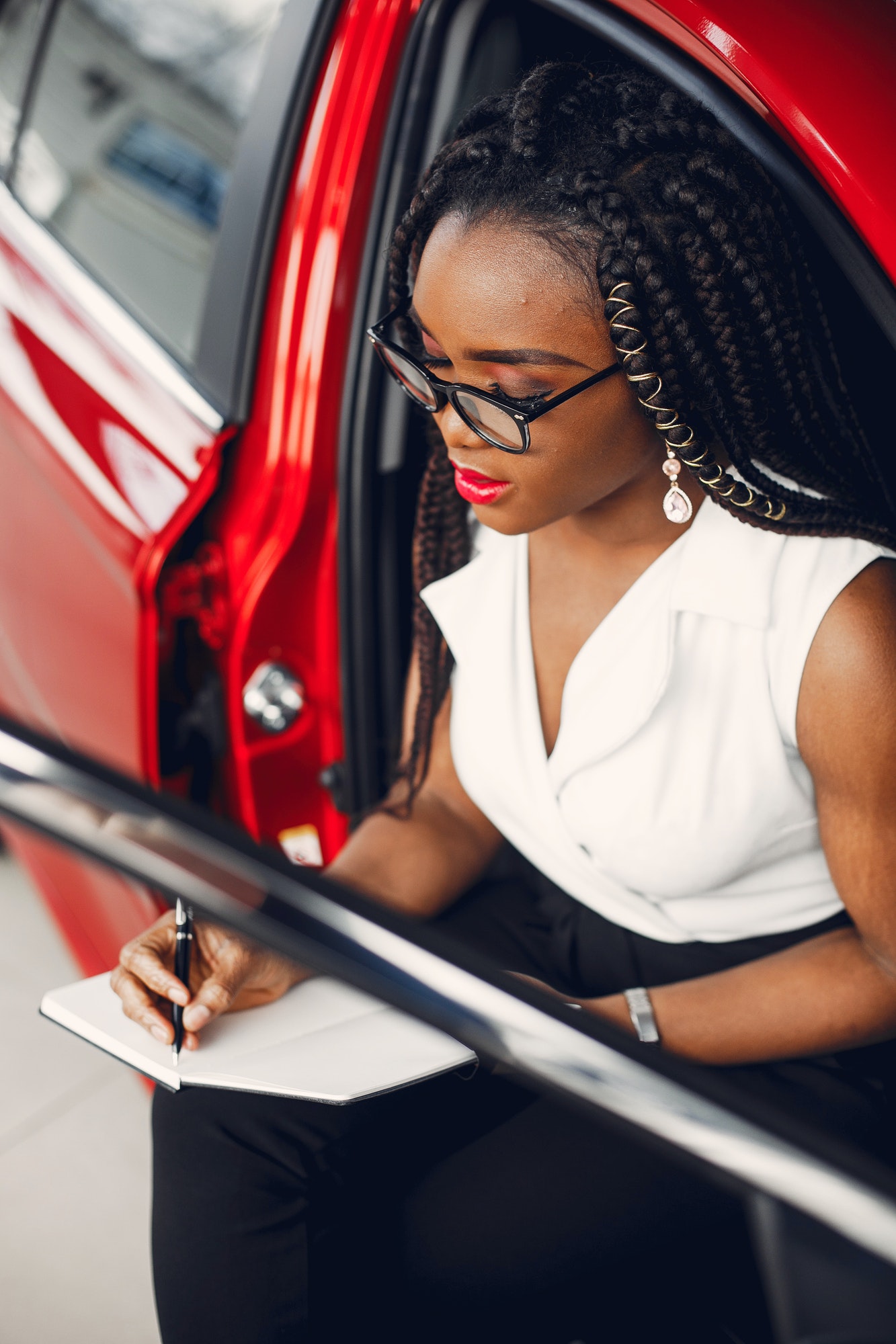 Stylish black woman in a car salon